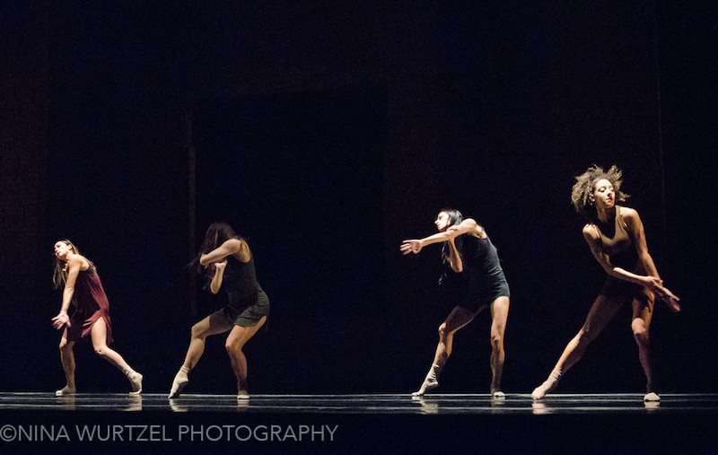 Four female dancers in slips and socks with their hair down